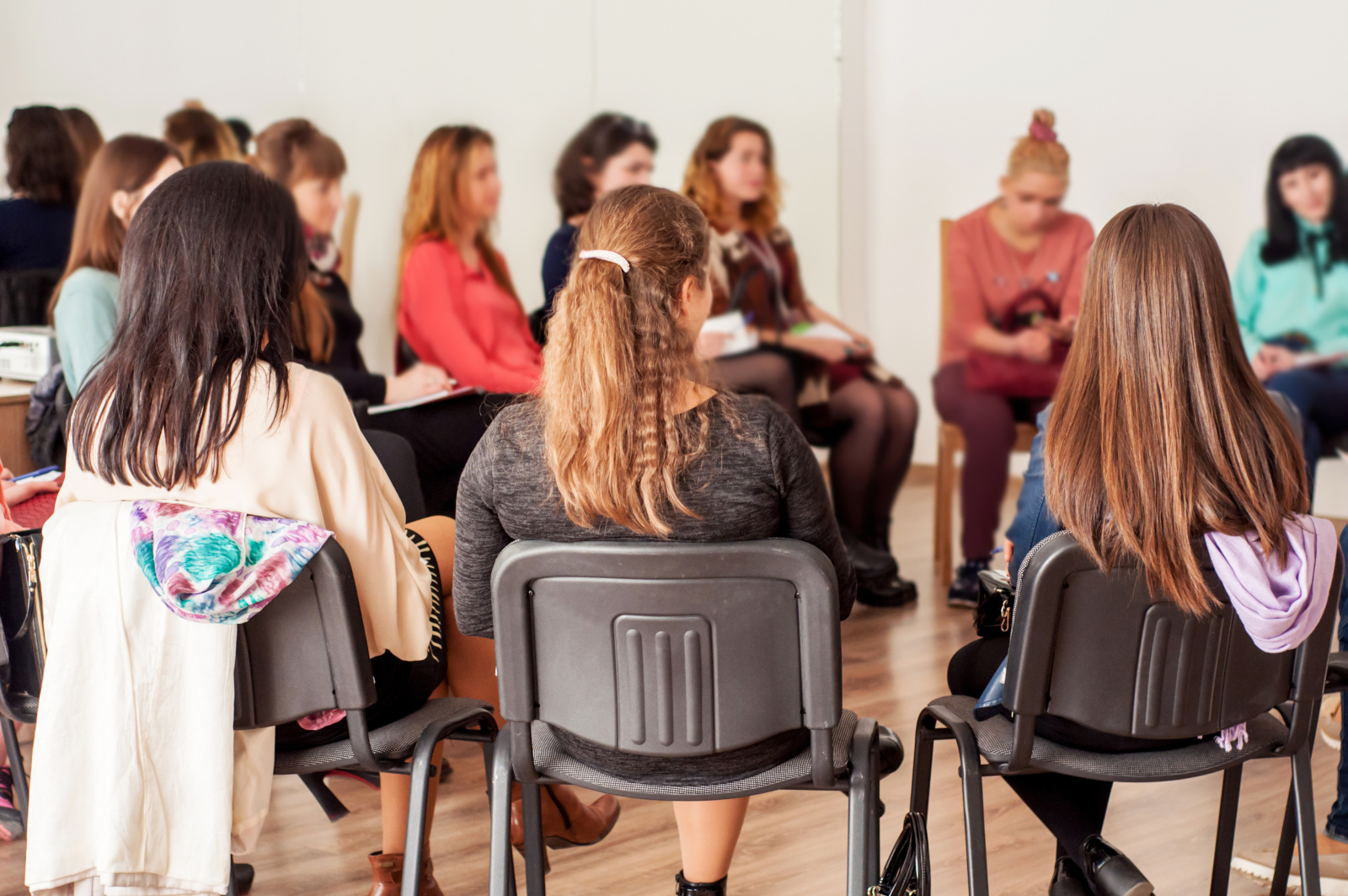 Group of young women talking sitting in a circle